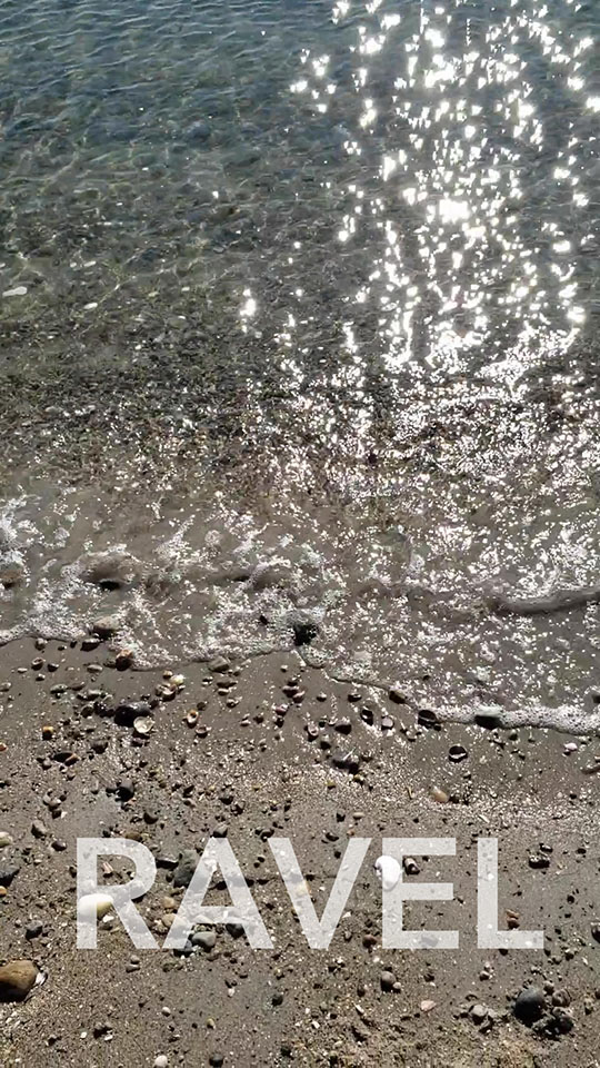 A beach and the word "RAVEL"